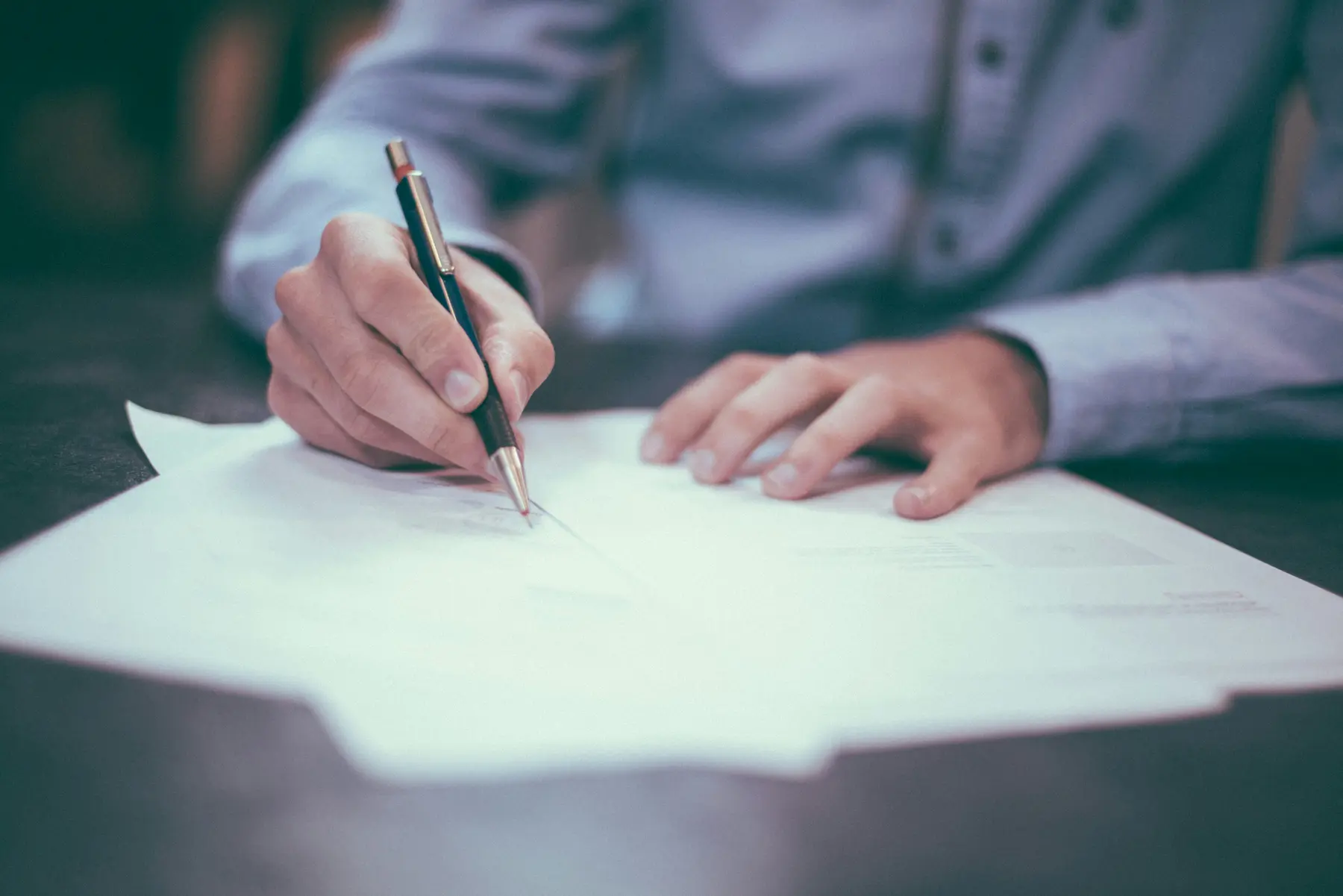 Professional reviewing and signing a document, claims investigation