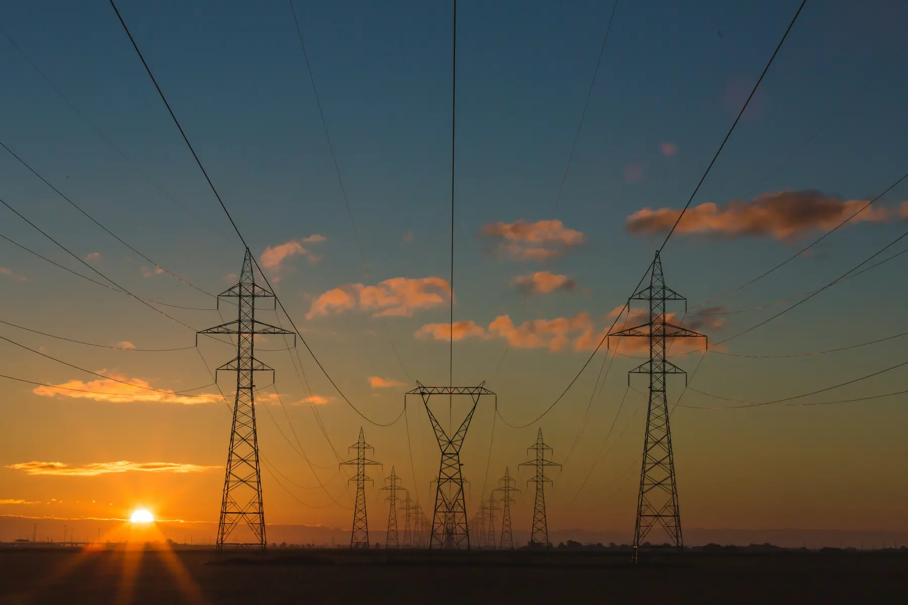 Large industrial facility with electrical infrastructure at sunset