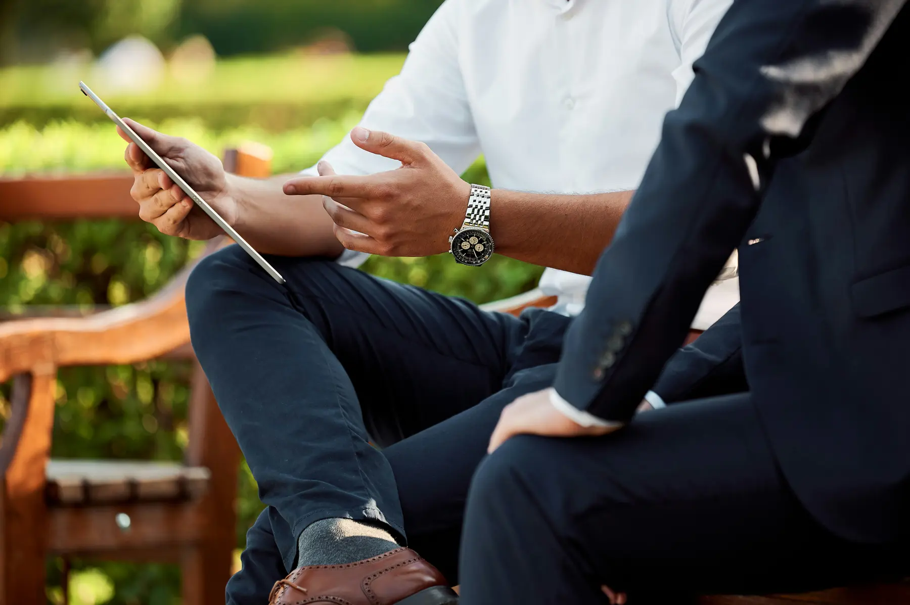 Two business professionals in consultation outdoors